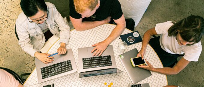 Aerial view of people working on laptops