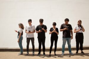 group of people looking at their phones