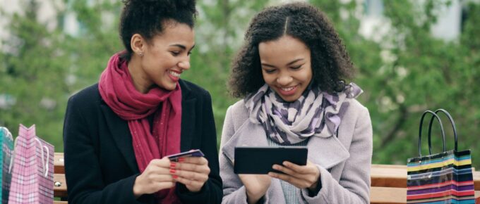 Two women looking at a tablet.